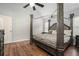 A main bedroom features a four poster bed, wood flooring, and natural light at 4077 High Country Dr, Douglasville, GA 30135