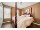 A secondary bedroom features a four poster bed, wood flooring, and natural light at 4077 High Country Dr, Douglasville, GA 30135