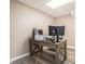 Office featuring wood-look floors and a wooden desk set up with multiple monitors and a laptop at 4077 High Country Dr, Douglasville, GA 30135