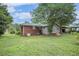 A generous backyard displaying a brick house and verdant lawn, creating an inviting outdoor space at 734 Meadowlark Dr, Villa Rica, GA 30180