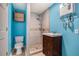 Modern bathroom with bright blue walls featuring stylish vanity, tiled shower, and energy-efficient water heater for added comfort at 734 Meadowlark Dr, Villa Rica, GA 30180