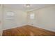 Comfortable bedroom with natural light, gleaming hardwood floors and a neutral color palette offering a relaxing and serene atmosphere at 734 Meadowlark Dr, Villa Rica, GA 30180