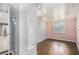Cozy bedroom featuring a modern mirror and shelving, with warm hardwood floors and light streaming through the window at 734 Meadowlark Dr, Villa Rica, GA 30180