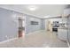 Bright kitchen featuring white tile floors, white cabinets, neutral-colored walls, and doorway to another room at 734 Meadowlark Dr, Villa Rica, GA 30180
