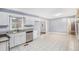 Bright kitchen showcasing white cabinets, stainless steel appliances, neutral countertops and tile flooring at 734 Meadowlark Dr, Villa Rica, GA 30180