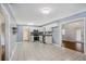 Spacious kitchen with white tile flooring, white cabinets, and stainless steel appliances, complemented by soft grey walls at 734 Meadowlark Dr, Villa Rica, GA 30180