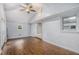 Large living room with hardwood floors, fan, and natural light, creating an inviting space for relaxation and entertainment at 734 Meadowlark Dr, Villa Rica, GA 30180