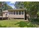 Exterior view of the back of the home with sunroom and raised deck at 136 Pine St, Covington, GA 30014