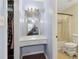 Bright bathroom featuring a vanity area with drawers, a framed mirror, and adjacent bath area at 136 Pine St, Covington, GA 30014