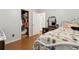 Bright bedroom featuring an open closet, hardwood floors, bed, and adjacent door entrance at 136 Pine St, Covington, GA 30014