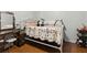 Charming bedroom featuring a vintage bed frame, wood floors, and a classic vanity with mirror at 136 Pine St, Covington, GA 30014