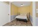 Bedroom with yellow accent wall is conveniently connected to kitchen at 136 Pine St, Covington, GA 30014
