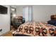 Comfortable bedroom featuring a ceiling fan, wood floors, a bed, and an open closet at 136 Pine St, Covington, GA 30014