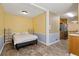 Bedroom with yellow accent wall is conveniently connected to kitchen at 136 Pine St, Covington, GA 30014