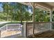 Charming covered porch with bright lighting, perfect for outdoor relaxation and enjoying the peaceful surroundings at 136 Pine St, Covington, GA 30014