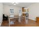 Bright dining room features hardwood floors, a table with chairs, and an adjacent kitchen for easy meal service at 136 Pine St, Covington, GA 30014