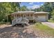 Cozy home with a covered porch, metal roof, attached garage, and a well-maintained front yard at 136 Pine St, Covington, GA 30014