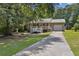 Inviting single-Gathering home with a white-railed porch, metal roof, and attached garage, set on a spacious lot at 136 Pine St, Covington, GA 30014