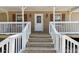 Close-up of the front porch with wooden steps and white railings, creating an inviting entrance to the home at 136 Pine St, Covington, GA 30014