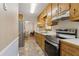 Traditional-style kitchen features stainless steel appliances and light wood cabinetry at 136 Pine St, Covington, GA 30014