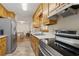 Traditional-style kitchen features stainless steel appliances and light wood cabinetry at 136 Pine St, Covington, GA 30014