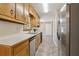 Functional kitchen featuring wood cabinets, stainless steel appliances, and ample counter space; ready for cooking at 136 Pine St, Covington, GA 30014