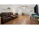 Spacious living room featuring hardwood floors and a ceiling fan, creating a comfortable and inviting atmosphere at 136 Pine St, Covington, GA 30014