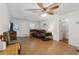 Well-lit living room with hardwood floors, comfortable seating, ceiling fan, and natural light; a welcoming space at 136 Pine St, Covington, GA 30014