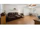 Well-lit living room with hardwood floors, ceiling fan, and comfortable seating, perfect for entertaining guests at 136 Pine St, Covington, GA 30014