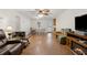 Open-concept living area featuring hardwood floors, ceiling fan, and ample space for dining and relaxing at 136 Pine St, Covington, GA 30014