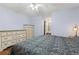 Bright main bedroom has hardwood floors and a ceiling fan at 136 Pine St, Covington, GA 30014