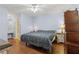 Comfortable main bedroom with hardwood floors and a ceiling fan at 136 Pine St, Covington, GA 30014