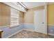 Cozy room with blue and yellow walls, tiled floors, and plenty of natural light at 136 Pine St, Covington, GA 30014
