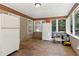 Bright sunroom featuring a wooden floor and multiple windows letting in natural light at 136 Pine St, Covington, GA 30014