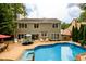 Exterior view of a home showcasing a swimming pool and outdoor seating area at 1767 Tidewell Trce, Lawrenceville, GA 30043
