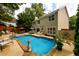 Private backyard pool with surrounding greenery, ideal for relaxation and entertainment at 1767 Tidewell Trce, Lawrenceville, GA 30043