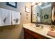 This powder room features updated fixtures, wainscoting, modern vanity and decorative towels at 1767 Tidewell Trce, Lawrenceville, GA 30043