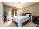 Comfortable bedroom featuring a queen-size bed, ceiling fan, and matching nightstands at 1767 Tidewell Trce, Lawrenceville, GA 30043