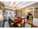 Formal dining room featuring a large table, hardwood floors, and natural lighting at 1767 Tidewell Trce, Lawrenceville, GA 30043