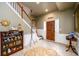 Inviting foyer featuring tiled flooring, a staircase with white railings, and stylish decor at 1767 Tidewell Trce, Lawrenceville, GA 30043