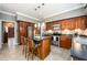 Modern kitchen features stainless appliances, center island with bar seating, and tile flooring at 1767 Tidewell Trce, Lawrenceville, GA 30043