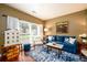 Cozy living room with a blue sofa, hardwood floors, and natural light from a large window at 1767 Tidewell Trce, Lawrenceville, GA 30043