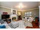 Comfortable living room features a fireplace, neutral paint, hardwood floors, and recessed lighting at 1767 Tidewell Trce, Lawrenceville, GA 30043