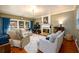 Cozy living room featuring a fireplace, hardwood floors, and natural lighting at 1767 Tidewell Trce, Lawrenceville, GA 30043