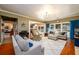 Spacious living room featuring hardwood floors, natural lighting, and modern furniture at 1767 Tidewell Trce, Lawrenceville, GA 30043