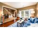 Bright living room featuring a blue sofa, hardwood floors, and a view into the foyer at 1767 Tidewell Trce, Lawrenceville, GA 30043