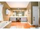 Spacious main bathroom featuring a soaking tub, dual sinks, vanity, and white cabinets at 1767 Tidewell Trce, Lawrenceville, GA 30043