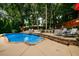 Backyard swimming pool surrounded by lush greenery and lounge chairs at 1767 Tidewell Trce, Lawrenceville, GA 30043