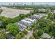 Aerial view showcasing new homes nestled amongst lush trees with a city skyline backdrop at 32 Walthall Ne St # A, Atlanta, GA 30307