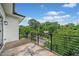 Balcony with black metal railing and a view of the trees and street at 32 Walthall Ne St # A, Atlanta, GA 30307